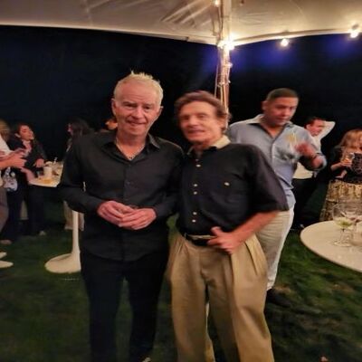 Two individuals engaged in animated conversation after a Pro-Am event.